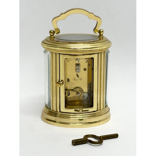 301 - A small L'Epee French brass carriage clock. With key and 5 bevelled glass panels. 9cm.