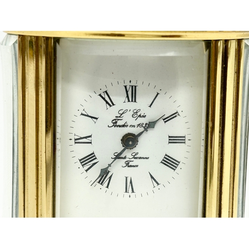 301 - A small L'Epee French brass carriage clock. With key and 5 bevelled glass panels. 9cm.