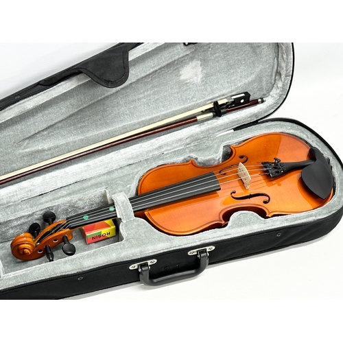 719 - A Gear 4 Music violin in case.