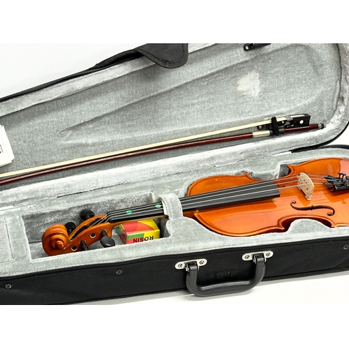 719 - A Gear 4 Music violin in case.