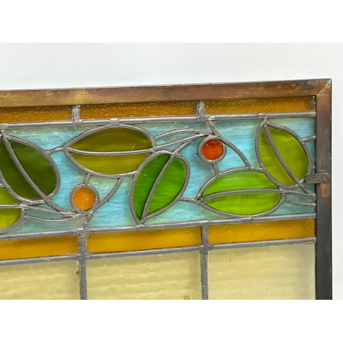 55A - A pair of large bronzed framed Early 20th Century stained glass panels. 111.5x40cm