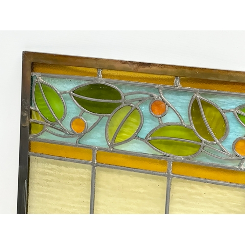 55A - A pair of large bronzed framed Early 20th Century stained glass panels. 111.5x40cm