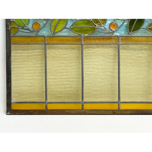 55A - A pair of large bronzed framed Early 20th Century stained glass panels. 111.5x40cm