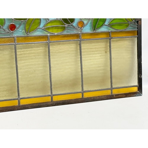 55A - A pair of large bronzed framed Early 20th Century stained glass panels. 111.5x40cm