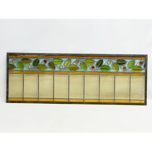 55A - A pair of large bronzed framed Early 20th Century stained glass panels. 111.5x40cm