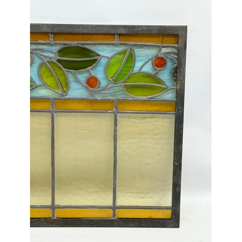 55A - A pair of large bronzed framed Early 20th Century stained glass panels. 111.5x40cm