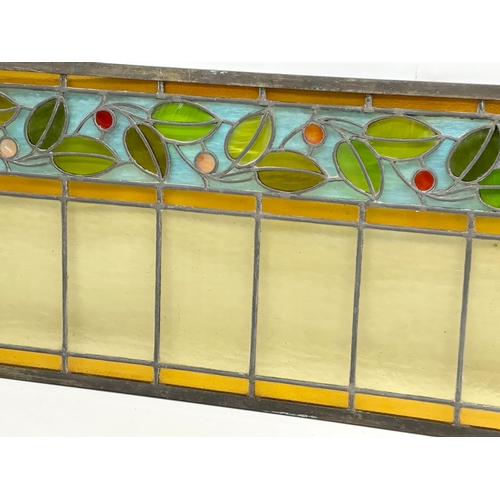 55A - A pair of large bronzed framed Early 20th Century stained glass panels. 111.5x40cm