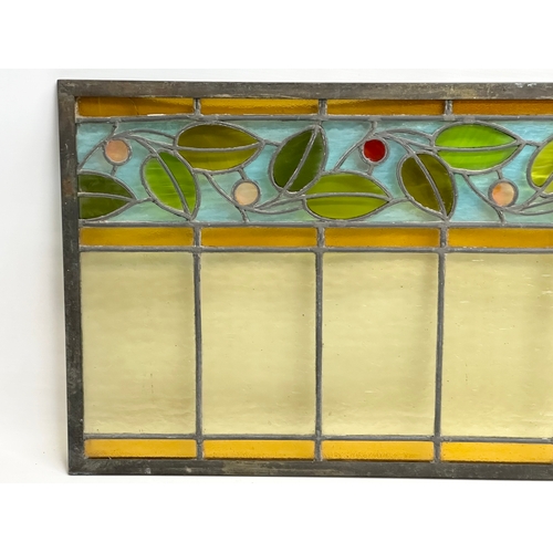 55A - A pair of large bronzed framed Early 20th Century stained glass panels. 111.5x40cm