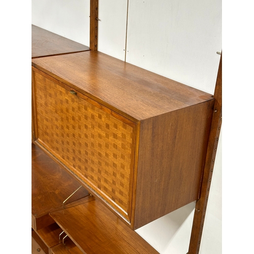 804 - Poul Cadovius. A Danish Mid Century teak “Royal System” modular wall unit. Designed by Poul Cadovius... 