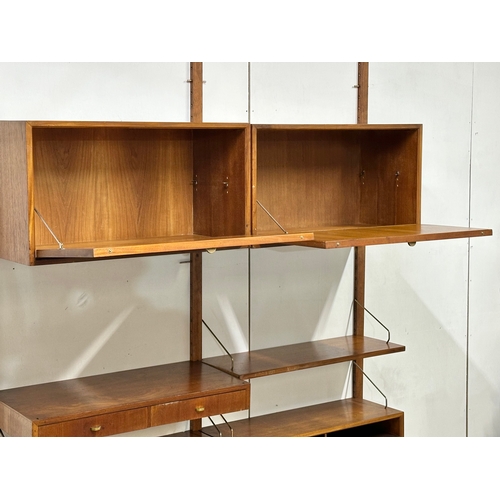 804 - Poul Cadovius. A Danish Mid Century teak “Royal System” modular wall unit. Designed by Poul Cadovius... 