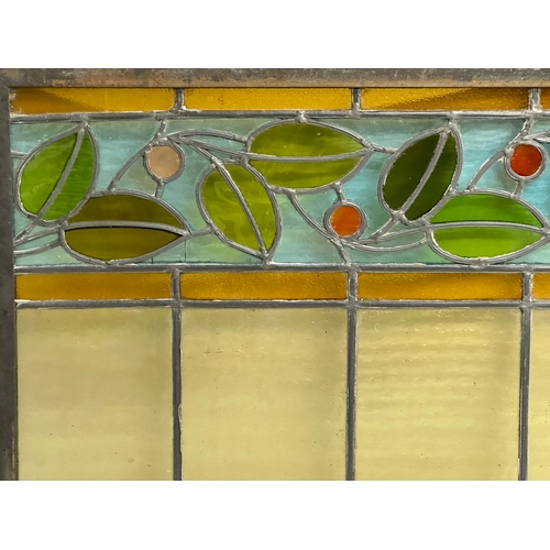 55B - A pair of large bronzed framed Early 20th Century stained glass panels. 111.5x40cm