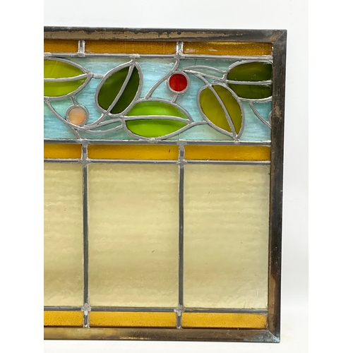 55B - A pair of large bronzed framed Early 20th Century stained glass panels. 111.5x40cm