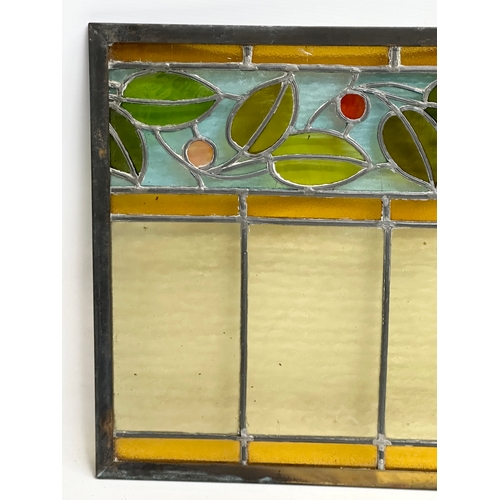 55B - A pair of large bronzed framed Early 20th Century stained glass panels. 111.5x40cm