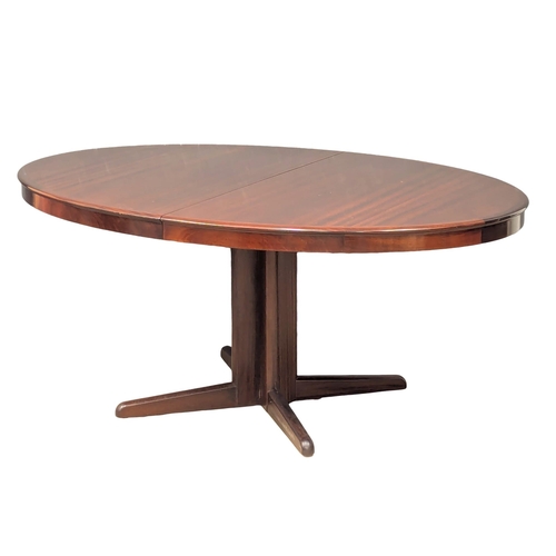 1053 - A Henry Walter Klein (H. W. Klein). A Danish Mid Century rosewood extending dining table and 8 chair... 