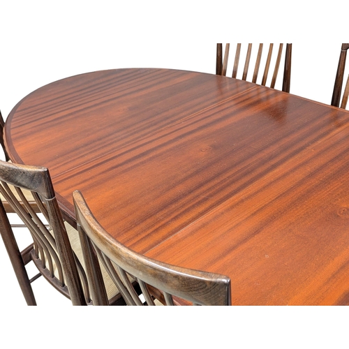 1053 - A Henry Walter Klein (H. W. Klein). A Danish Mid Century rosewood extending dining table and 8 chair... 