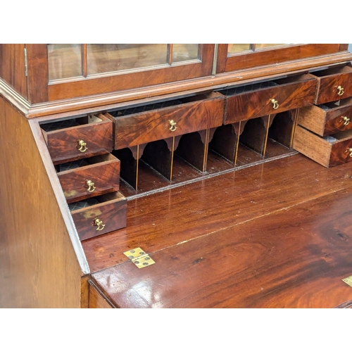 1078 - A large George III mahogany bureau bookcase with astragal glazed doors. Circa 1800. 99x56x228cm (8)