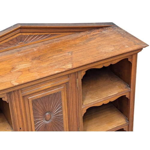 1076 - A Late Victorian low walnut cabinet with shelves and cupboard door. Circa 1890s. 111x34x87.5cm.(9)