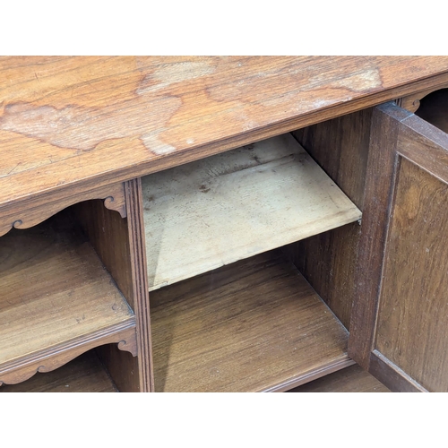 1076 - A Late Victorian low walnut cabinet with shelves and cupboard door. Circa 1890s. 111x34x87.5cm.(9)