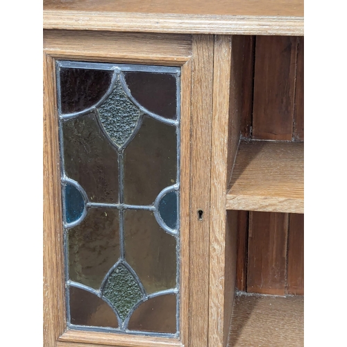 1062 - A Late 19th Century / Early 20th Century oak Arts & Crafts bookcase with two lead glass doors. Circa... 