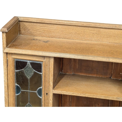 1062 - A Late 19th Century / Early 20th Century oak Arts & Crafts bookcase with two lead glass doors. Circa... 