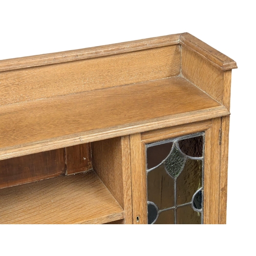 1062 - A Late 19th Century / Early 20th Century oak Arts & Crafts bookcase with two lead glass doors. Circa... 