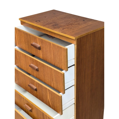 1085 - A Mid Century teak chest of drawers. 69x41x106cm(11)