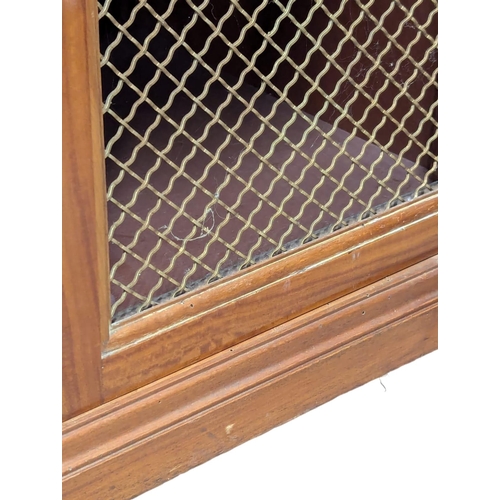 1093 - A 18th Century style inlaid Satinwood breakfront bookcase with brass wired mesh door in the Sheraton... 