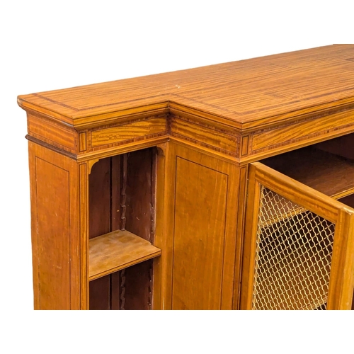 1093 - A 18th Century style inlaid Satinwood breakfront bookcase with brass wired mesh door in the Sheraton... 