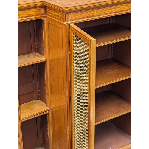 1093 - A 18th Century style inlaid Satinwood breakfront bookcase with brass wired mesh door in the Sheraton... 