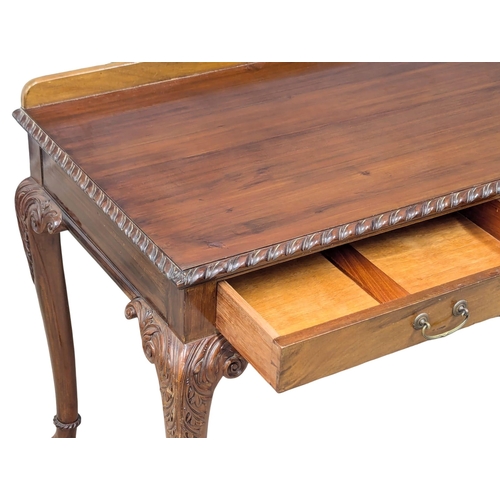 1071 - A large 1930s Chippendale Revival mahogany side table with 2 drawers on Ball & Claw feet. 122x60x84c... 