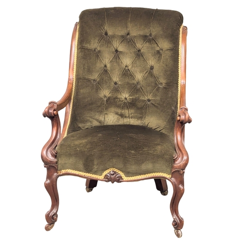 942 - A Victorian mahogany framed open armchair with deep button back upholstery. (7)