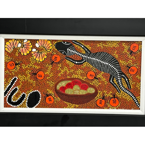 694 - A signed Aboriginal oil painting. 47x14cm. Frame 61x38cm