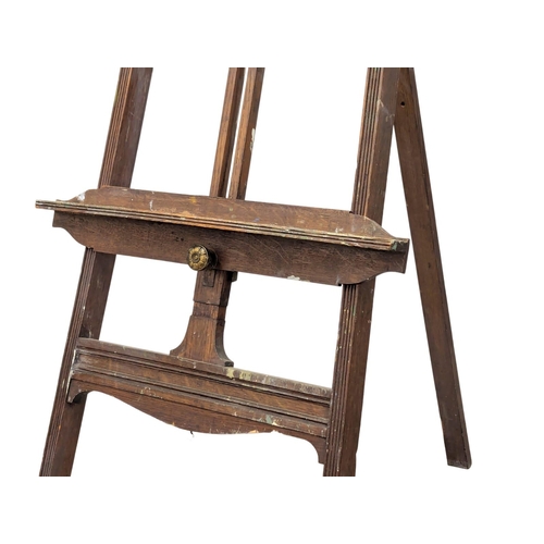 1029 - A Late 19th Century oak artists easel in the Aesthetic Movement. Circa 1890-1900. 56x190cm (1)