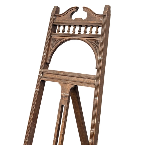 1029 - A Late 19th Century oak artists easel in the Aesthetic Movement. Circa 1890-1900. 56x190cm (1)