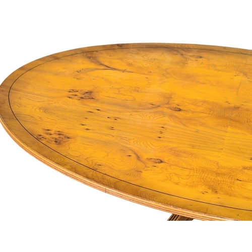 1040 - A Georgian style inlaid yew wood pedestal coffee table on brass lion paw feet. 128x76.5x55cm (3)