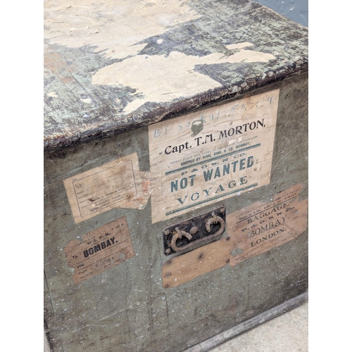 828 - A 19th Century pine trunk with original finish and traveling labels. Captain T. M. Morton. 82.5x53x5... 