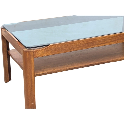 858 - A Mid Century teak coffee table with smoked glass top by Myer. 88x44x35cm(10)