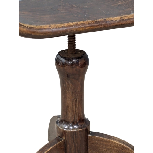 859 - A Late 19th Century / Early 20th Century mahogany revolving stool. (2)