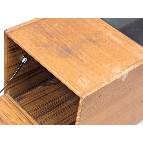 866 - A McIntosh Mid Century teak coffee table with smoked glass top and storage. 121.5x44x43cm (10)