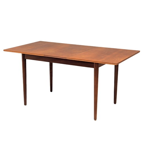 884 - A Mid Century teak extending dining table and 6 chairs by Gordon Russell. 1 leaf. 154x84x74cm extend... 