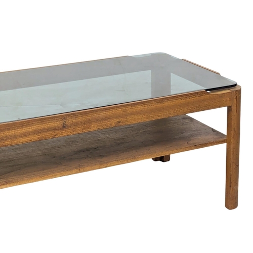 885 - A Mid Century teak framed and smoked glass coffee table by Myer.(1)