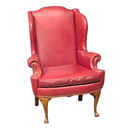 892 - A vintage Georgian style wingback armchair.(6)