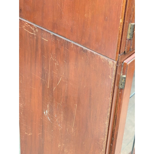 911 - A 1930s mahogany sectional bookcase with lead glass doors by Minty. 89x29x150cm(1)