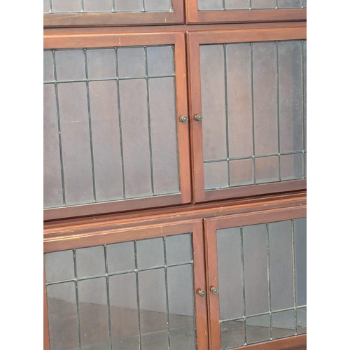 911 - A 1930s mahogany sectional bookcase with lead glass doors by Minty. 89x29x150cm(1)