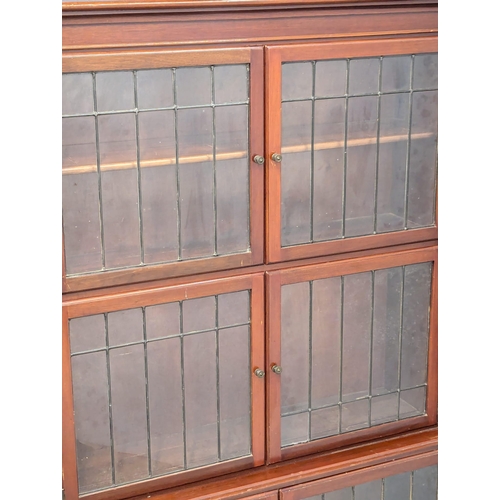 911 - A 1930s mahogany sectional bookcase with lead glass doors by Minty. 89x29x150cm(1)