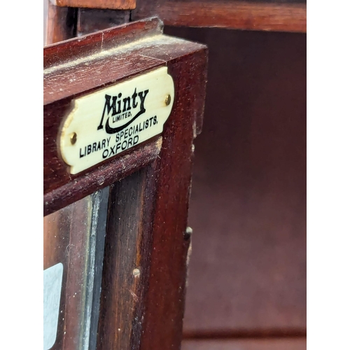 911 - A 1930s mahogany sectional bookcase with lead glass doors by Minty. 89x29x150cm(1)