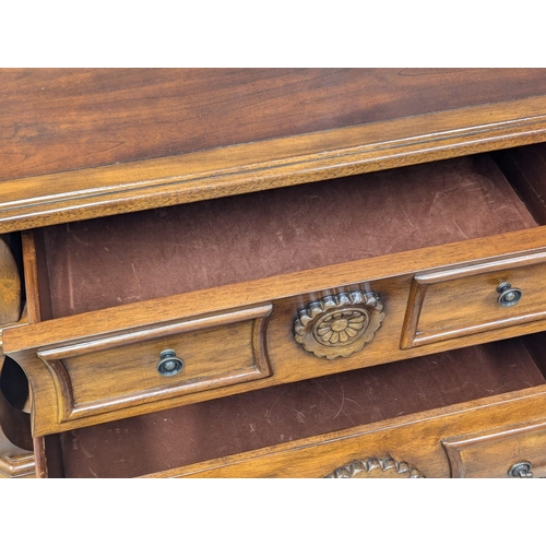 915 - A Bombe shaped black walnut chest of drawers. 86.5x51x84cm (2)