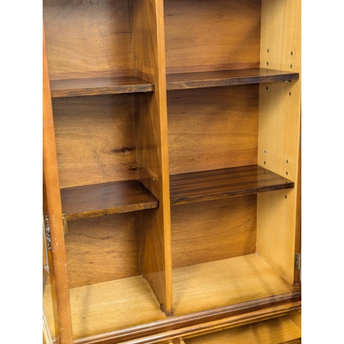 934 - A Georgian style yew wood bookcase with astragal glazed doors. 137x32x194.5cm (2)