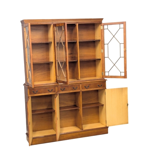 934 - A Georgian style yew wood bookcase with astragal glazed doors. 137x32x194.5cm (2)