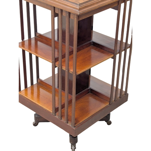 939 - An Edward VII inlaid mahogany revolving bookcase. Edwardian. 49x88cm (7)